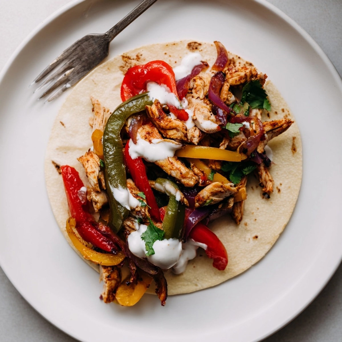 Sizzling Chicken Fajitas with Lime Crema, a colorful skillet bursting with fresh Tex-Mex flavors.