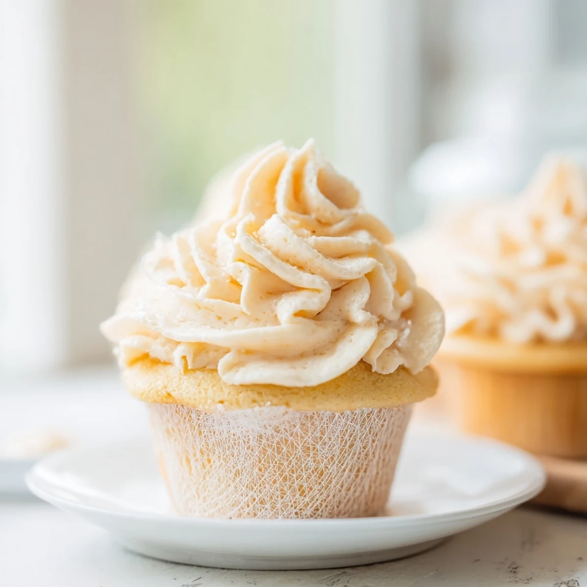 Fluffy vanilla cupcakes with buttercream frosting, a classic dessert perfect for any occasion.