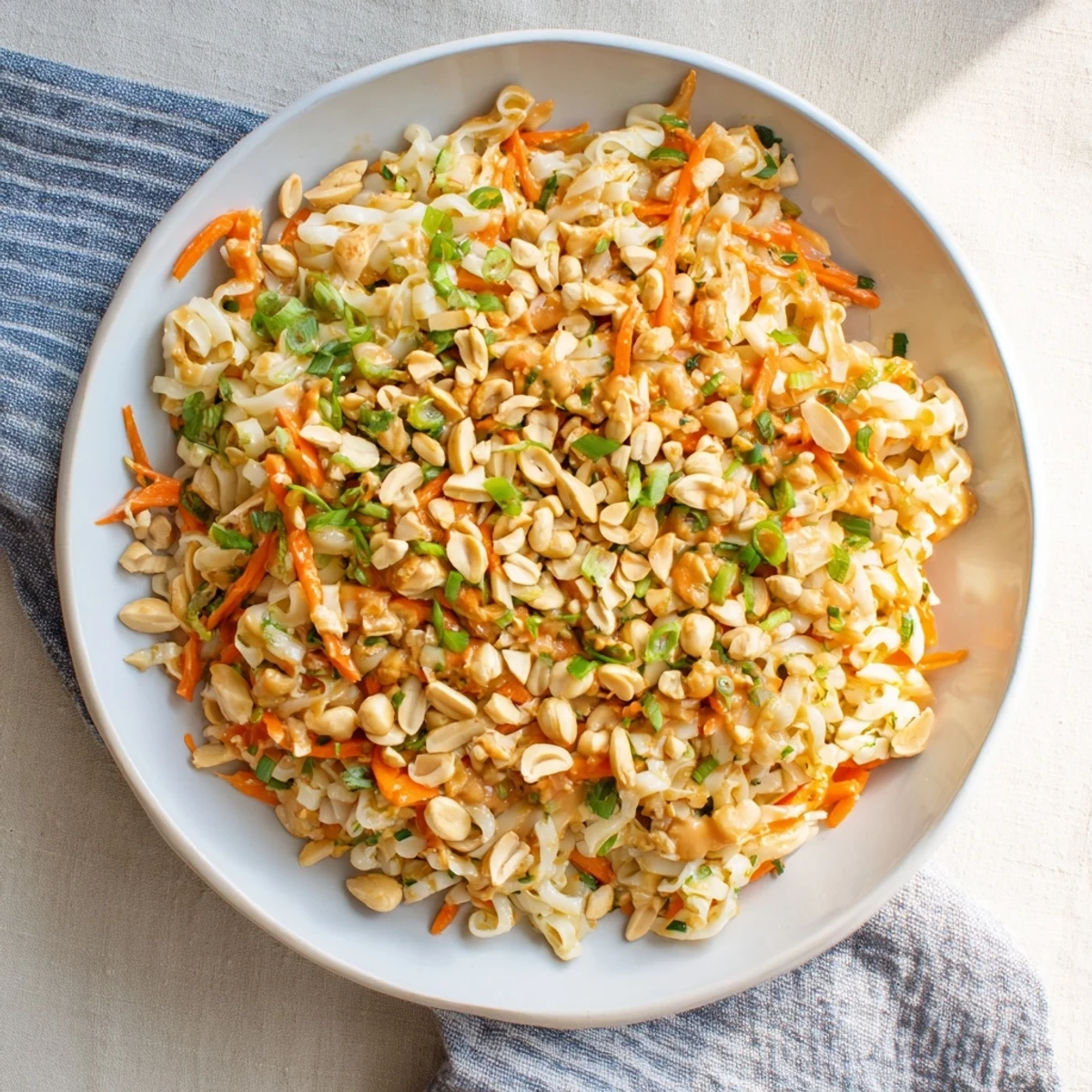 Close-up of a Spicy Peanut Noodle Salad with vibrant vegetables and a creamy peanut dressing.