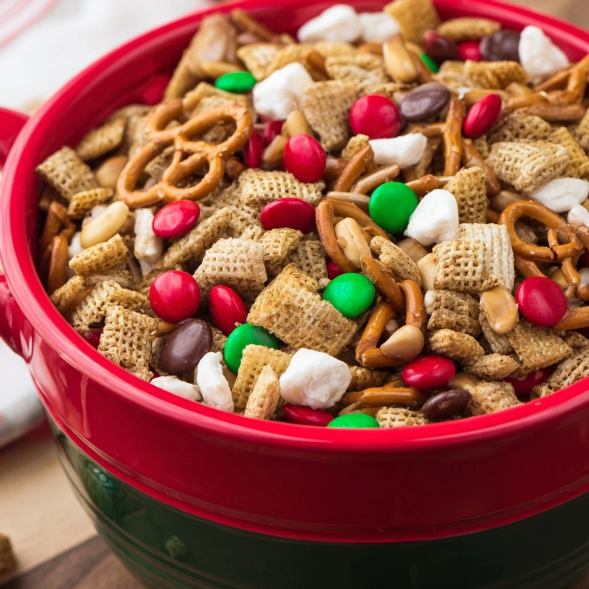A vibrant bowl overflows with delicious homemade Holiday Mix, crunchy and sweet-and-salty.