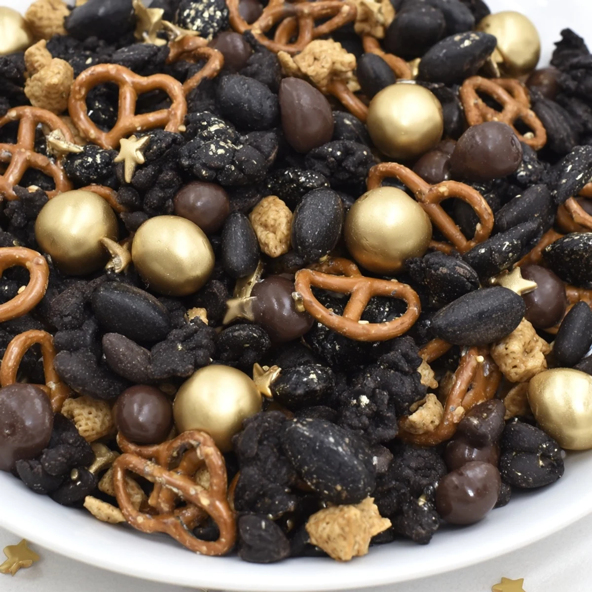 Golden and black midnight snack mix, a crunchy, sweet & savory treat, ready for New Year's.