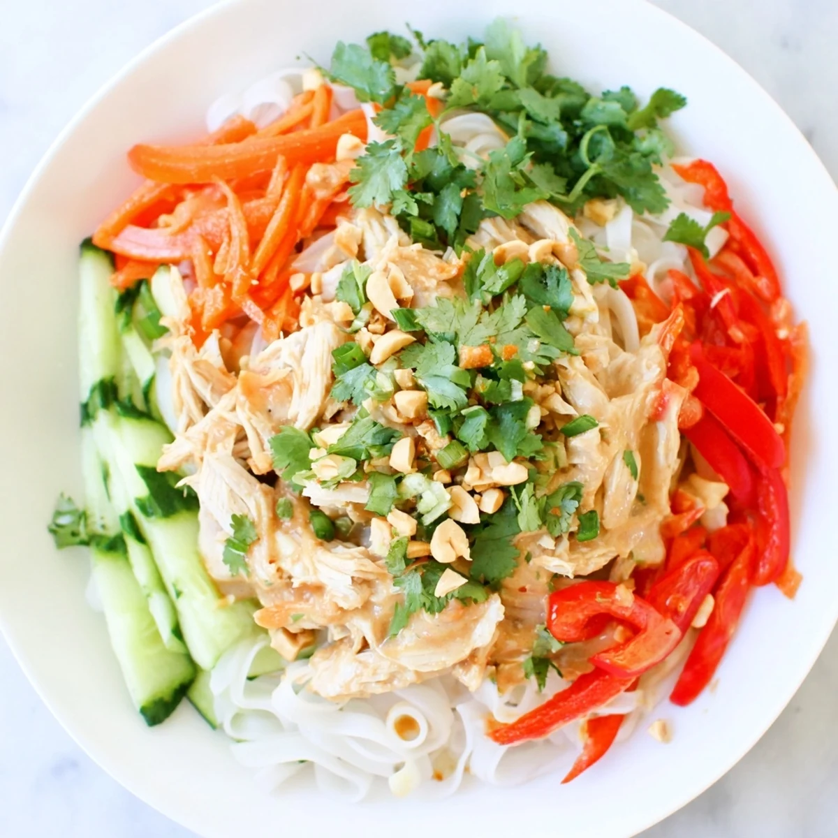 Thai-Inspired Peanut Chicken Pasta, a delicious summer dish with colorful vegetables and creamy peanut dressing.