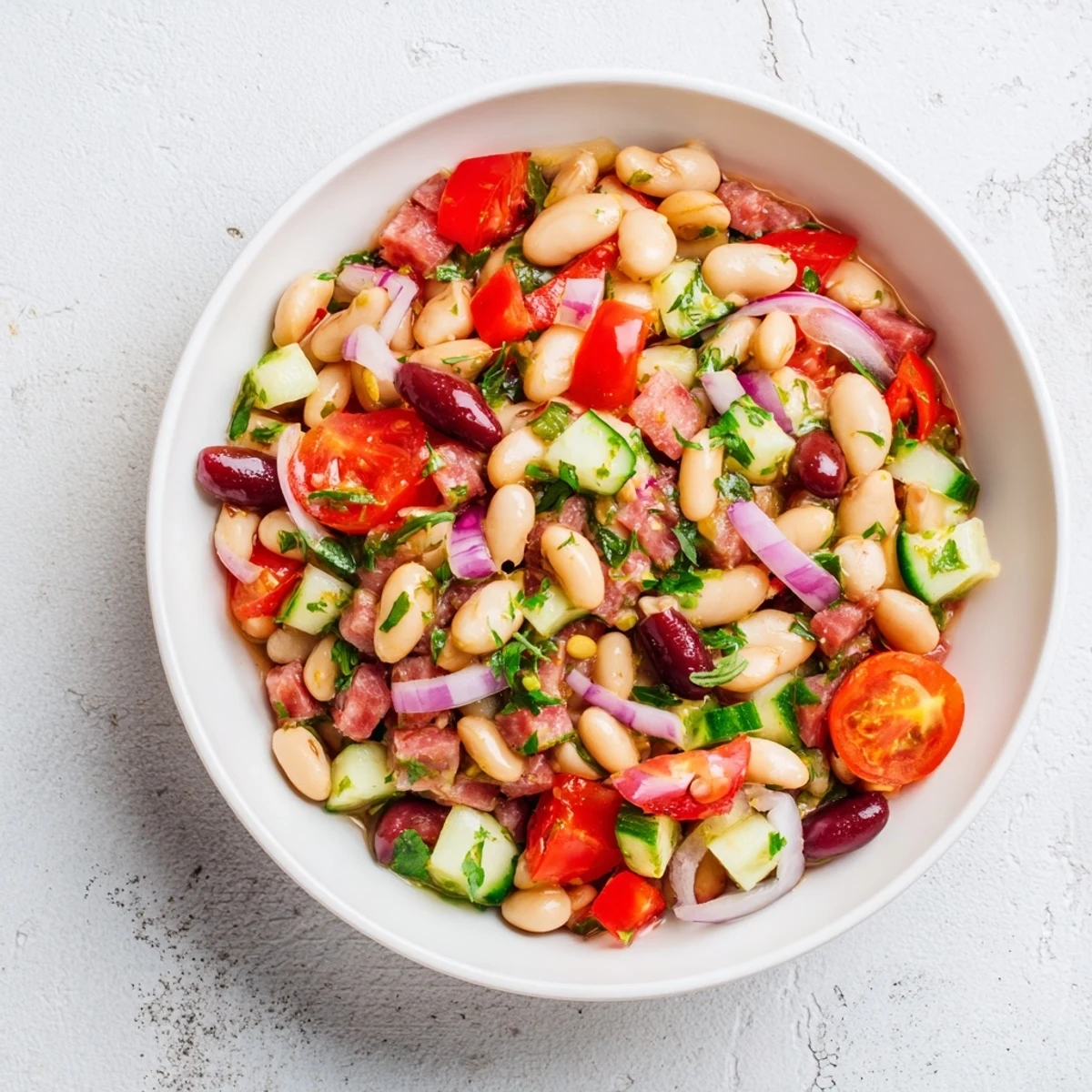 Mediterranean Dense Bean Salad with salami, a vibrant mix of beans, salami, and fresh vegetables, ready to serve.