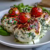 Fresh Caprese skewers with pesto drizzle, featuring juicy cherry tomatoes, creamy mozzarella, and fragrant basil for a perfect summer appetizer.  