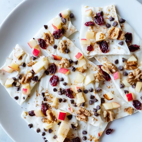 Frozen Apple Cinnamon Yogurt Bark glistening with fresh apple pieces and a cinnamon dusting.