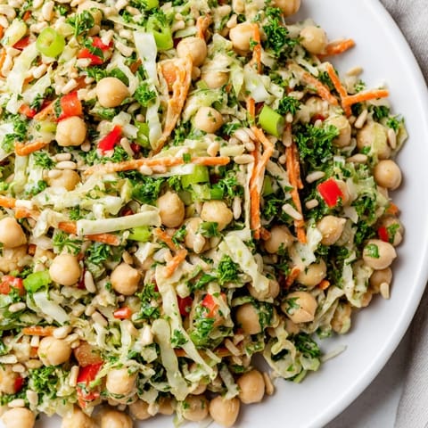 Creamy tahini dressing coats this fresh Fiber-Forward Chickpea Salad, a healthy and satisfying lunch option.