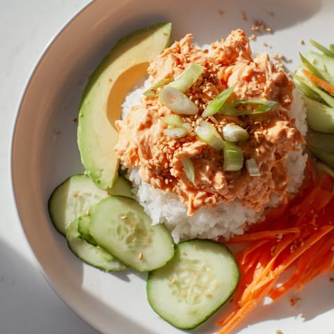 A close-up of a beautifully composed Spicy Canned Salmon Rice Bowl bursting with fresh, vibrant flavors.
