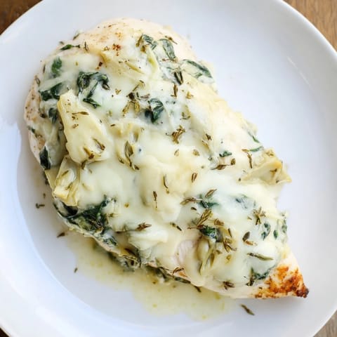 Tender chicken breasts smothered in a tangy spinach, artichoke, and Greek yogurt cheese sauce.