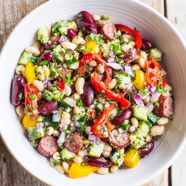 This Mediterranean Dense Bean Salad with salami is a colorful, hearty salad featuring flavorful salami and briny olives.