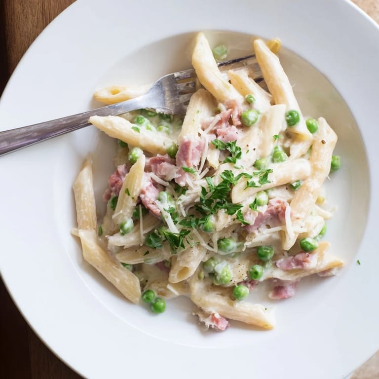 A hearty, comforting plate of Spring Pea & Ham Pasta featuring sweet peas and diced ham mixed into penne.