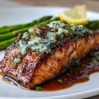 Garlic Butter Salmon with Asparagus roasted on a sheet pan with vibrant green asparagus and lemon slices in a golden garlic butter sauce.