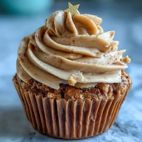 A dozen vanilla cupcakes with rich terracotta buttercream, perfect for Taurus birthdays and earthy celebrations.