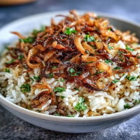 Levantine Mujadara with incredibly crispy onions, a hearty vegetarian rice and lentil dish.